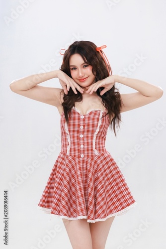 Cuadro en lienzo Playful Asian Beauty Woman in Red Gingham Dress with Clean Skin and Korean Makeu
