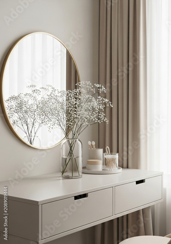 Dressing table setup with round mirror, floral arrangement and cream-colored stool
