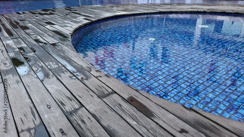 swimming pool and wet wooden flooring