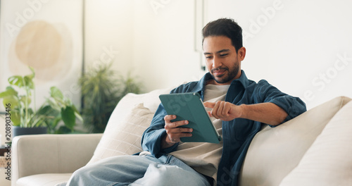 Tableau sur toile Streaming, digital or man on sofa with tablet, video subscription or post update on online site