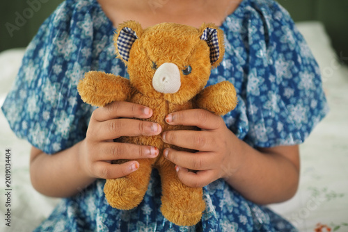Photos Holding a cherished teddy bear, a moment of childhood joy