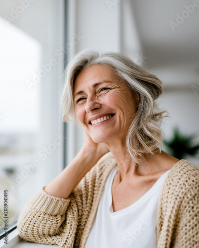 Womens health menopause smiling woman near window relaxed confident portrait in natural light
