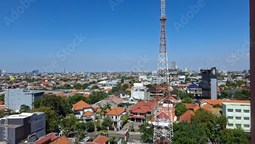 A cityscape featuring a tower and buildings with a clear sky