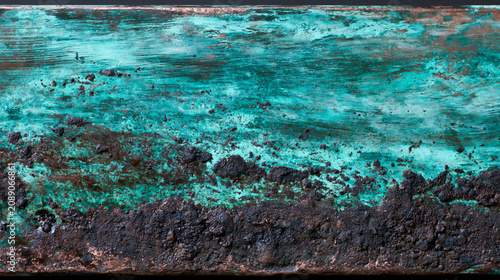 Abstract background texture of weathered oxidized copper sheet with green verdigris patina and grunge scratches