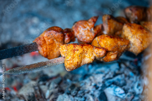 Pork Skewers Grilling Over Charcoal Sparks