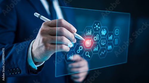 A business professional using a digital interface to manage strategic corporate goals and performance metrics for growth