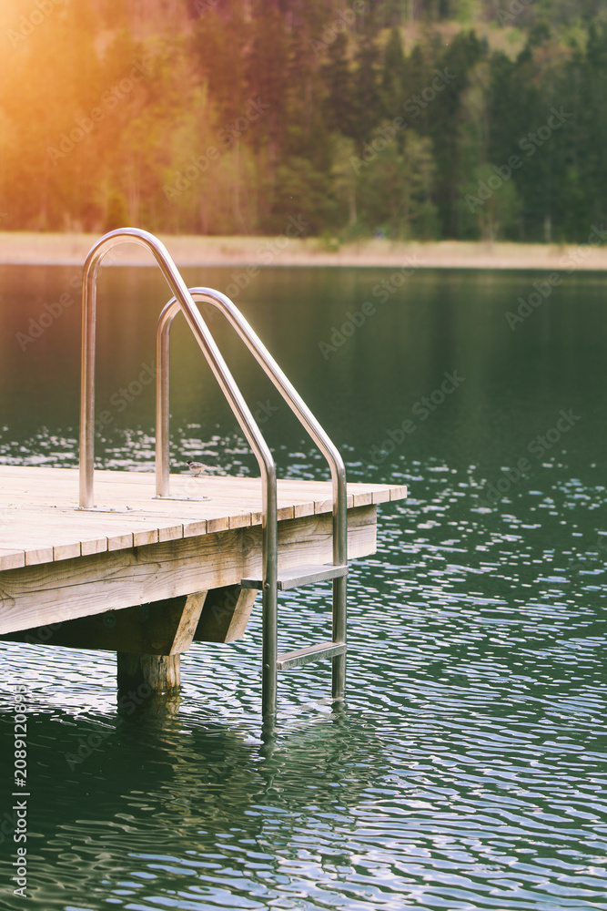 Fototapeta premium Clear alpine lake with wooden pier