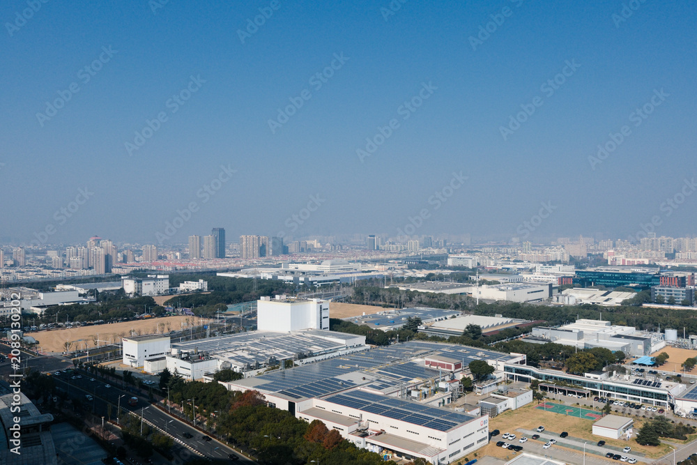 Fototapeta premium Industrial city district under blue sky