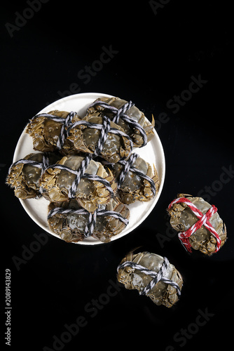 Fresh Yangcheng Lake Hairy Crabs from Suzhou China Tied with Rope on White Plate Premium Seafood Delicacy