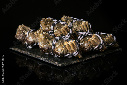 Fresh Yangcheng Lake Hairy Crabs from Suzhou China Tied with Rope on Dark Slate Plate