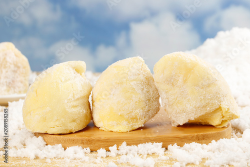 Golden Durian Ice Cream Scoops with Powder on Wooden Board