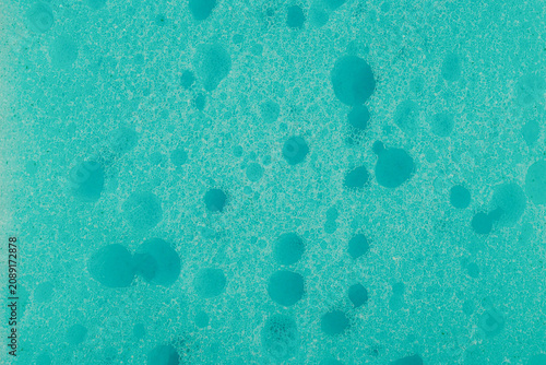 Fotografie Close up of a porous blue sponge surface