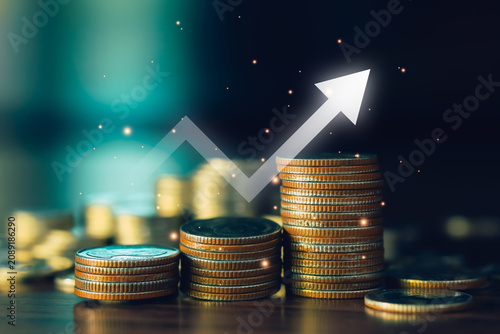 Investment growth concept with stacked coins and upward arrow representing financial success, business expansion, increasing profits, wealth accumulation, economic development and smart investing.
