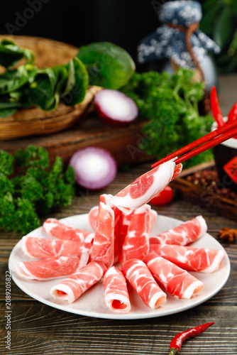 Premium Raw Beef and Lamb Rolls for Shabu Shabu Hot Pot with Fresh Vegetables and Red Chopsticks