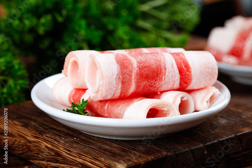 Raw Beef Slices Rolled on Plate for Hot Pot Cooking - Premium Quality Meat Cuts