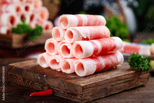 Premium Raw Beef Rolls on Wooden Board - Quality Fatty Meat for Fondue and Hot Pot Cooking