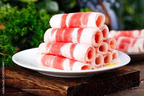 Thinly Sliced Marbled Beef Rolls on Plate Ready for Hot Pot Cooking