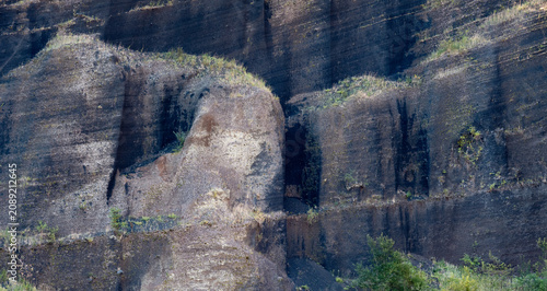 Fotografie Dark volcanic scoria wall on Croscat volcano in Catalonia, Spain