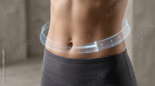 Close up of waistline with digital measuring tape symbolizing weight loss and BMI tracking to help manage obesity and improve health through body measurement and fitness