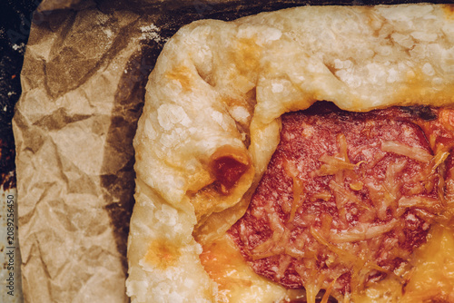 Homemade rustic pizza with sausage and cheese. Shot from above.
