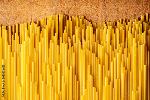 Dry spaghetti as textured background. Shot from above. Background and textures.