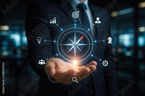 Businessman holding glowing digital compass with navigation strategy icons for leadership planning corporate direction vision and decision making in dark office environment