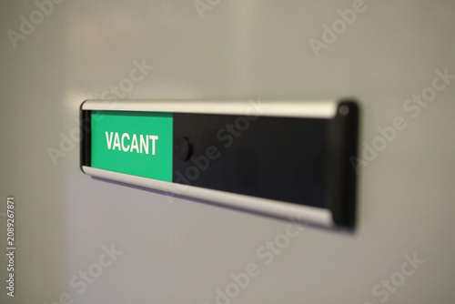 Fotografie Vacant room occupancy sign mounted on wall with selective focus, modern office a