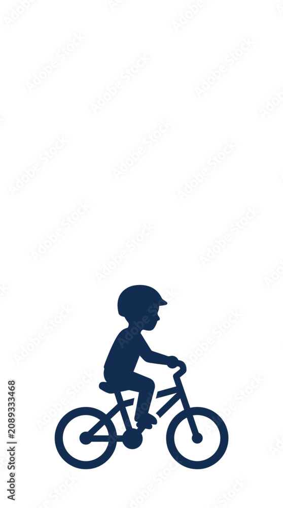 Obraz premium A dark blue silhouette of a young child riding a bicycle.