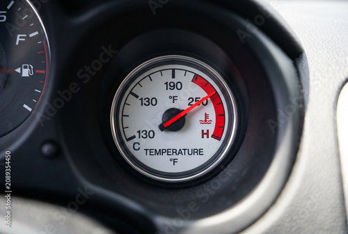 Car engine temperature gauge showing high reading on dashboard for overheating warning and vehicle maintenance indicator