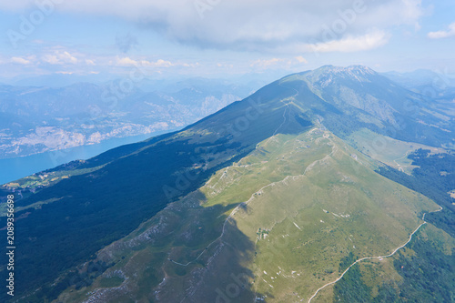 Aerial panoramic view of the Rubiana region on Lake Garda with the impressive Monte Baldo mountain range in northern Italy. Captured during a paragliding flight