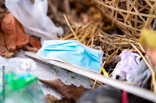 Obraz na plátně Used face mask discard in household garbage