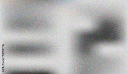 Grayscale abstract grain effect with soft blurred dark shapes offering a sophisticated textured surface design