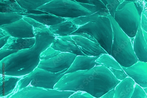 Abstract green wave background. A green background with a subtle wave texture creates a harmonious and natural impression. Fluid curves and soft transitions between shades of green add depth, movement