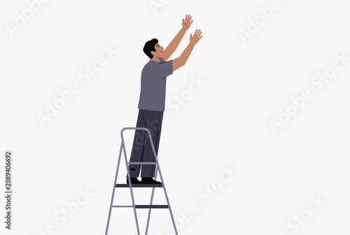 Young man standing on a metal stepladder reaching upwards with his arms outstretched to perform a task or grab something high up.