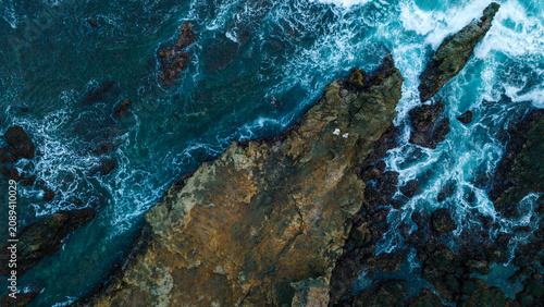 Bild auf Leinwand Crashing Waves at Watulumbung Beach with Rocky Islet at Sunset, Yogyakarta, Indo