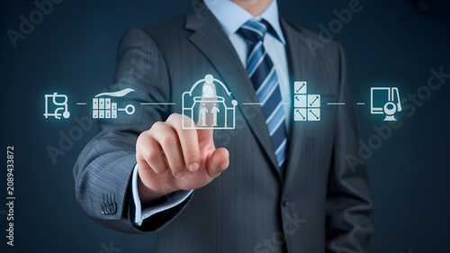 Business executive pointing at digital process workflow diagram featuring various industrial and management icons for strategic enterprise operations.