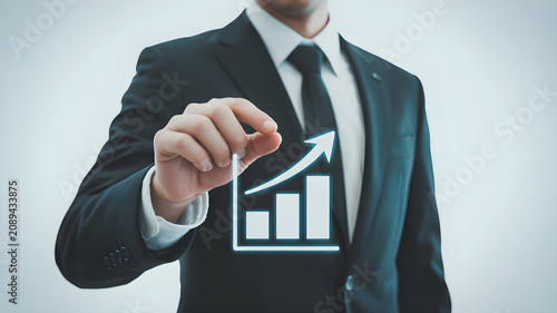 Businessman hand holding glowing bar graph with upward arrow, representing business growth success and financial progress or investment.