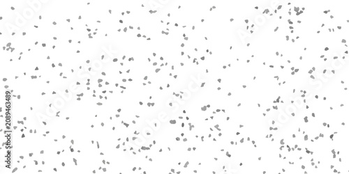 A dense scattering of small, irregular grey shapes are distributed across a pure white background.