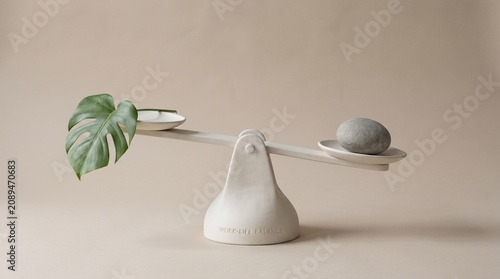 Ceramic balance scale showing a green monstera leaf weighed against a simple smooth grey stone object