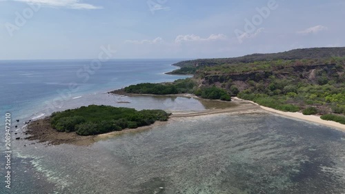 Aerial drone shot with a tilt reveal of  Sea Baluran National  Park and Mount Baluran in East Java Indonesia
