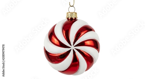 A round red and white striped christmas ornament with a shiny finish, hanging from a small metal hook, isolated on a white background