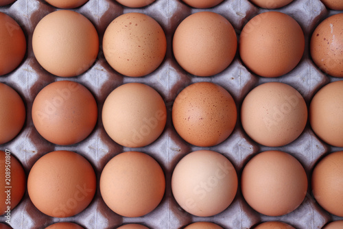 Fresh brown eggs in an egg carton.