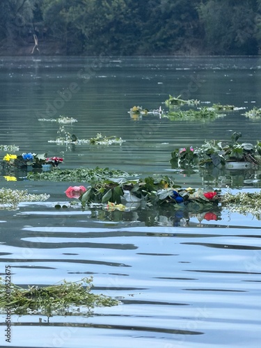 Traditional flower wreaths floating on calm water during the Ivan Kupala celebration. Peaceful summer evening scene with Slavic folklore, ritual traditions, and natural floral decorations.