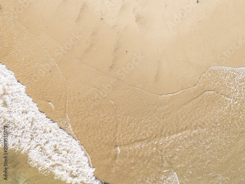 Captured from a drone directly overhead, the meeting of the turquoise sea and white sand makes for a stunning backdrop