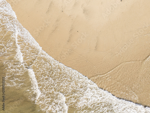 Captured from a drone directly overhead, the meeting of the turquoise sea and white sand makes for a stunning backdrop