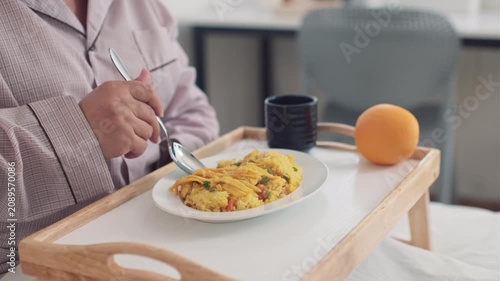 Hospital patient eating a healthy meal during recovery with balanced nutrition and medical care.