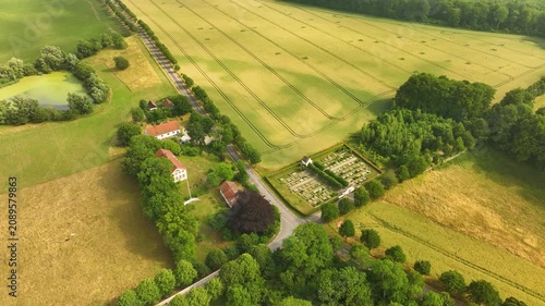 Aerial view of a country road and cemetery in a rural landscape