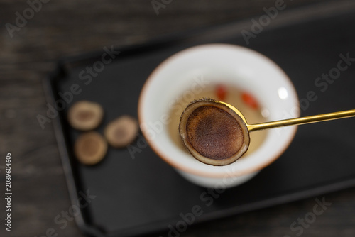 Quadro su tela Close up of velvet antler slice on a golden spoon with traditional Chinese herba