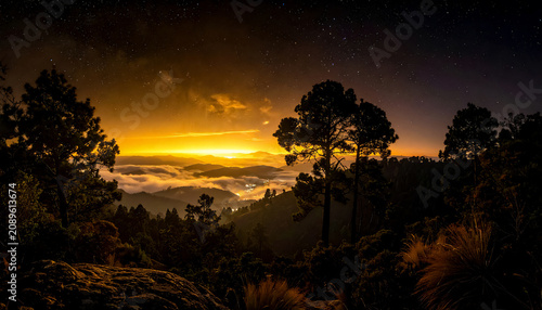A night sky dotted with a colossal number of densely packed stars, light merges into a single, dense silvery or golden glow, a luminous fog