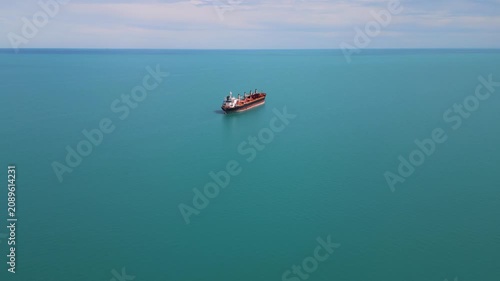 Aerial View of Cargo Ship Anchored in Calm Turquoise Sea